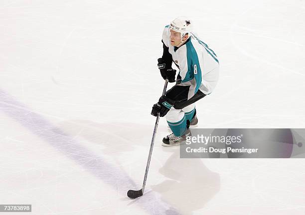 Matthew Carle of the San Jose Sharks handles the puck during the game against the Colorado Avalanche at the Pepsi Center on March 18, 2007 in Denver,...