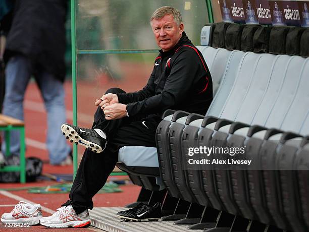 Sir Alex Ferguson the Manchester United manager changes into his boots during the Manchester United training session ahead of their UEFA Champions...