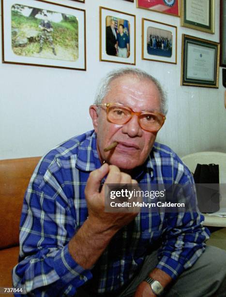 French fugitive businessman Alfred Sirven smokes a cigar while in custody February 2, 2001 in Manila, Philippines after being arrested hours earlier...