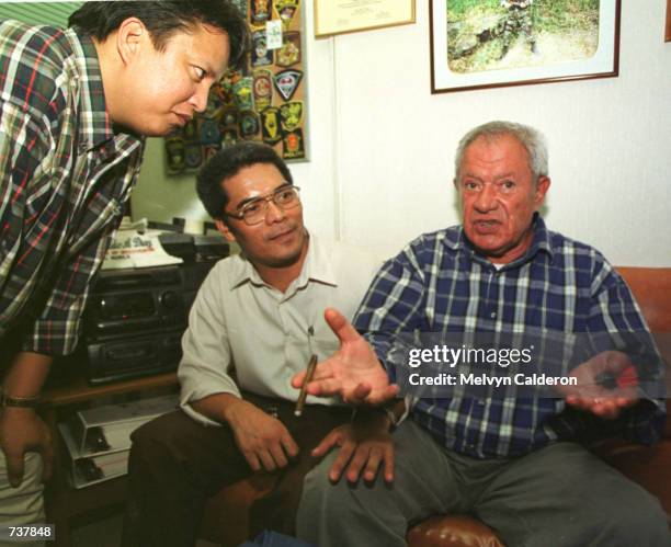 Fugitive French businessman Alfred Sirven, right, asserts his innocence while talking with James Tosoc of the National Bureau of Investigation,...