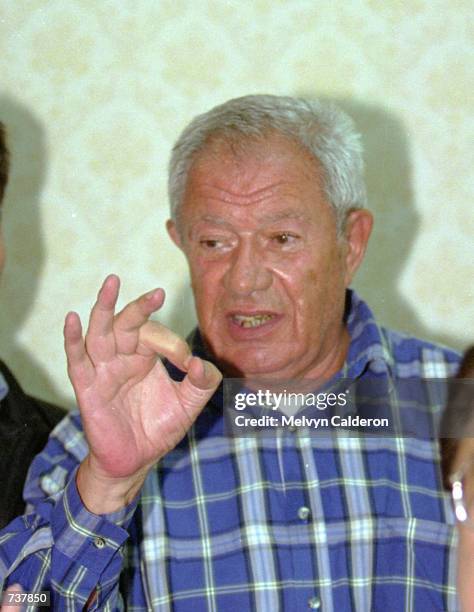 Fugitive French businessman Alfred Sirven gestures while talking to reporters February 2, 2001 in Manila, Philippines after being arrested hours...