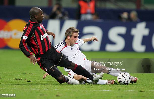 Clarence Seedorf of Milan and Philipp Lahm fight for the ball during the UEFA Champions League quarter final, first leg match between AC Milan and...