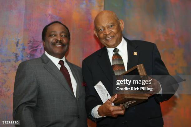 Joe Morgan poses with Don Motley who accepted Beacon of Life Award of Buck O'Neil the during the MLB Beacon Awards Luncheon at the Peabody Hotel in...