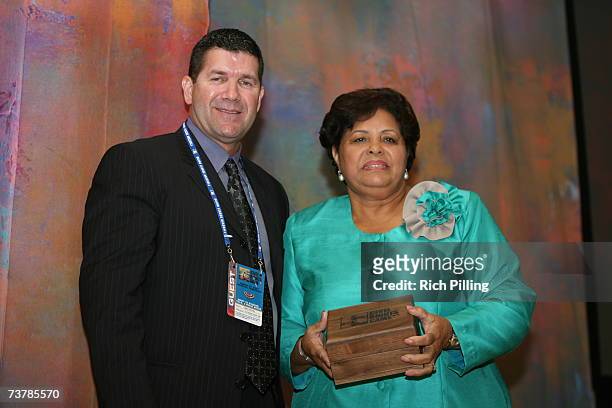 Edgar Martinez poses with Vera Clemente who accepted Beacon of Hope Award the during the MLB Beacon Awards Luncheon at the Peabody Hotel in Memphis,...