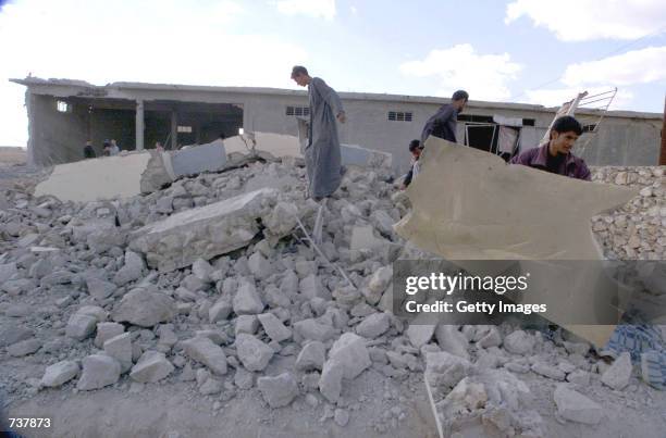 Iraqis sift through the rubble of a destroyed house Janauary 21, 2001 in Samawa, some 186 miles, 300 kms, south of Baghdad, Iraq. Iraqi officials say...