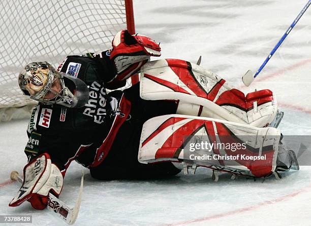 Goalie Adam Hauser of the Haie lies disappointed on the ice after the Adler have scored the sixth goal during the DEL Play Off semi final match...