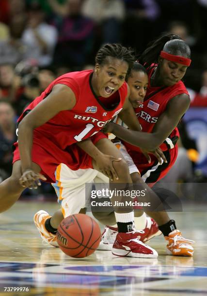 Shannon Bobbitt of the Tennessee Lady Volunteers fights for the loose ball against Epiphanny Prince and Matee Ajavon of the Rutgers Scarlet Knights...