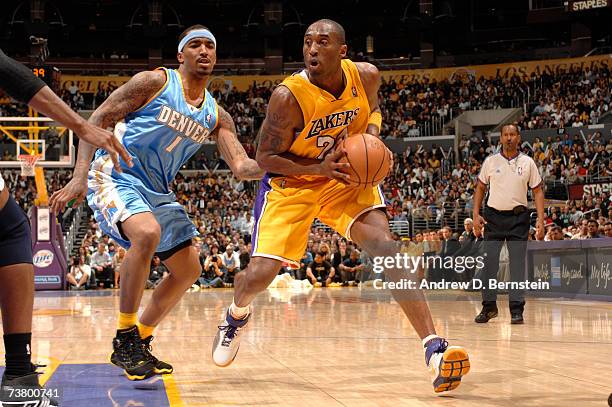 Kobe Bryant of the Los Angeles Lakers drives to the hoop against J.R. Smith of the Denver Nuggets on April 3, 2007 at Staples Center in Los Angeles,...