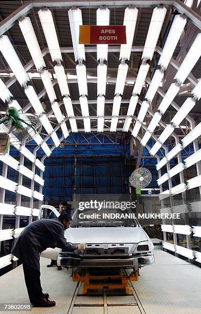 Employees assemble a Logan car at the Mahindra's car manufacturing facility in Nashik, some 200 kms north-east of Mumbai, 04 April 2007. Mahindra...