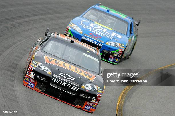 Johnny Sauter driving the Yellow Transportation Chevrolet leads Tony Raines driving the DLP HDTV Chevrolet on Turn 2 during NASCAR Richmond Testing...