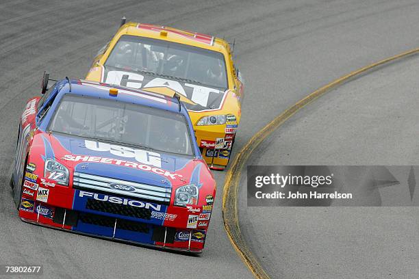 Matt Kenseth driving the USG/Dewalt Ford leads Dave Blaney driving the Caterpiller Toyota on Turn 2 during NASCAR Richmond Testing at Richmond...