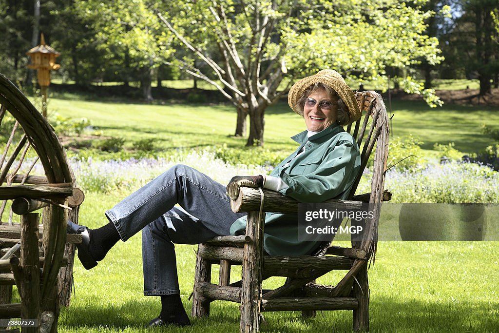 Mature woman relaxing in garden