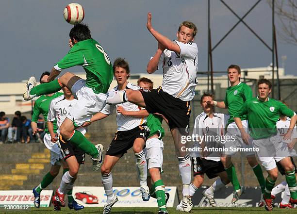 Manuel Konrad of Germany heads the ball with Robert Bayly of Ireland during the Men's U19 international friendly match between Ireland and Germany on...