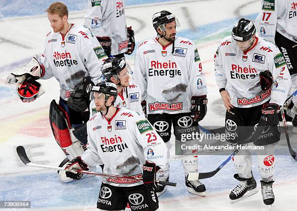 Players of Cologne look dejected after their defeat during the DEL Bundesliga play off semi final game between Adler Mannheim and Cologne Haie at the...