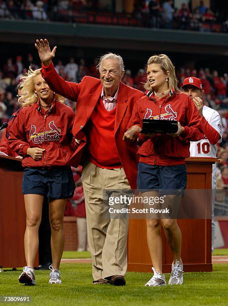 St. Louis Cardinals Hall of Famer Stan Musial waves to te fans after receiving his World Series ring from manager Tony LaRussa during a ceremony...