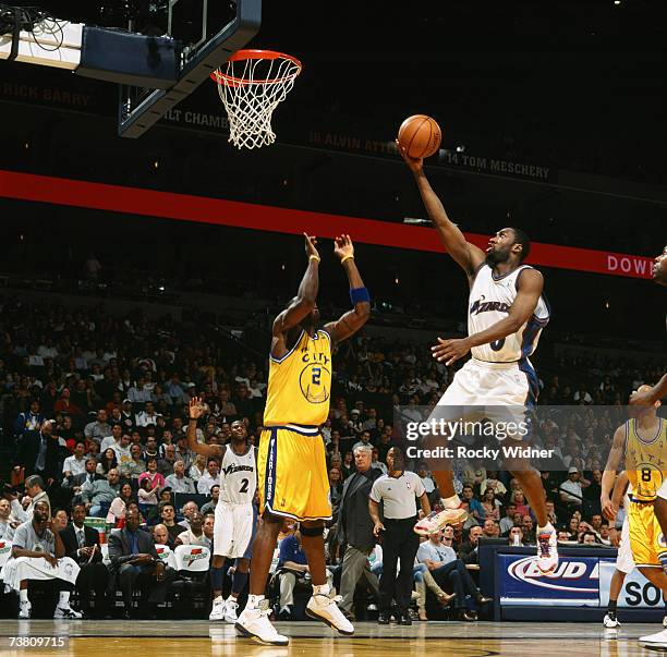 Gilbert Arenas of the Washington Wizards shoots a layup against Mickael Pietrus of the Golden State Warriors during a game at Oracle Arena on March...