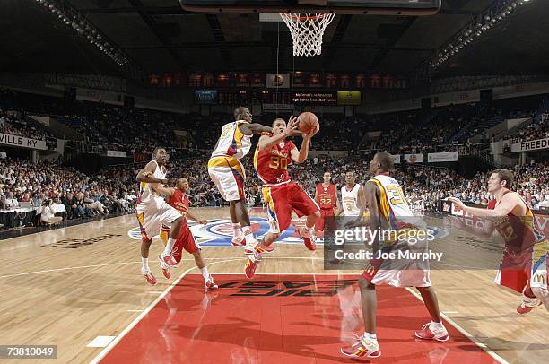 Michael Beasley of the West Team drives down the lane against J.J. Hickson of the East Team during the Boy's McDonald's All American High School...