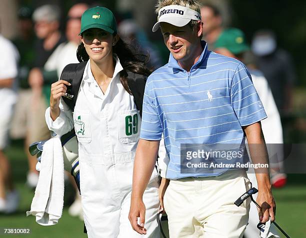 Luke Donald of England walks with his fiance Diane Antonopoulos during the Par-3 contest prior to the start of The Masters at the Augusta National...