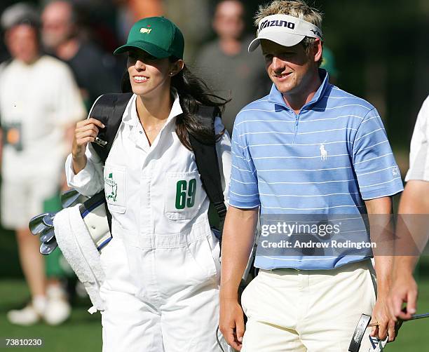 Luke Donald of England walks with his fiance Diane Antonopoulos during the Par-3 contest prior to the start of The Masters at the Augusta National...