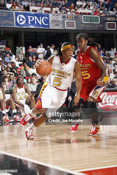 Khadijah Rushdan of the East Team dribbles against Devereaux Peters of the West Team during the Girl's McDonald's All American High School Basketball...