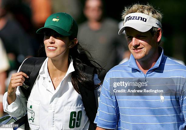 Luke Donald of England walks with his fiance Diane Antonopoulos during the Par-3 contest prior to the start of The Masters at the Augusta National...