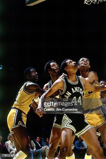 George Gervin of the San Antonio Spurs boxes out against Kareem Abdul-Jabbar of the Los Angeles Lakers during a game played in 1980 at the Great...