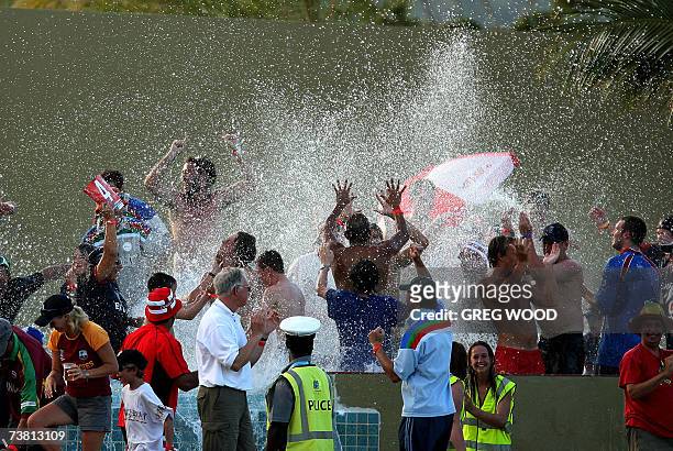 St John's, ANTIGUA AND BARBUDA: England fans go crazy in a specially constructed swimming pool as a six is scored in the closing stages of their...