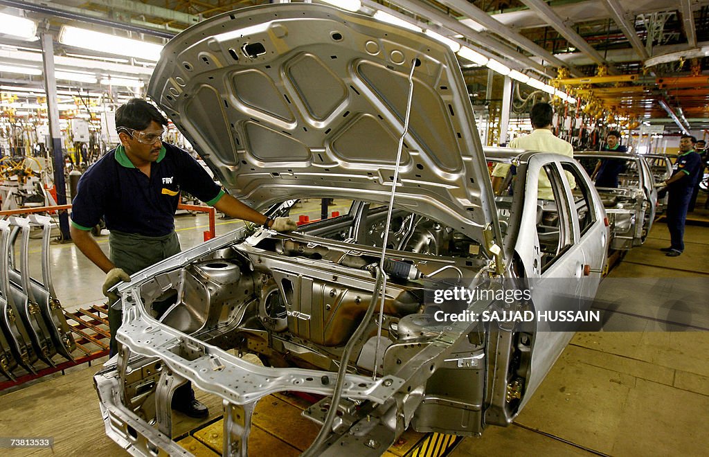 An Indian employee works on the producti...