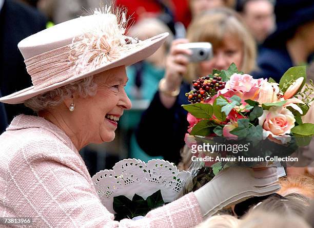 Queen Elizabeth ll receives a bouquet of flowers during a walkabout outside Manchester Cathedral following the traditional Royal Maundy Service on...