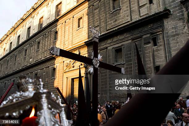 Members of "La Lanzada" brotherhood carry a Cross in front of the Seville Cathedral as they walk during their procession on April 4, 2007 in Seville,...