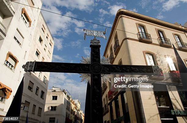 Cross carried by a member of "El Baratillo" brotherhood is seen during their procession on April 4, 2007 in Seville, Southern Spain. The Holy Week of...