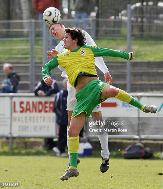 Pirmin Lechthaler of Munich and Stefan Guschke of Rostock jump to head for the ball during the DFb Juniors German Cup between Hansa Rostock and 1860...