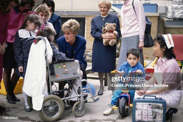 Princess Diana, wearing a Chanel suit, talking to patients at the Great Ormond Street Children's hospital in London, March 1991.