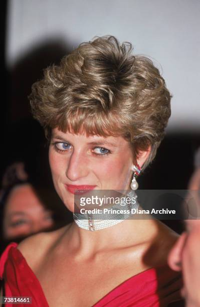 The Princess of Wales attends a performance of 'Simon Boccanegra' at the Royal Opera House in Covent Garden, 12th November 1991. She is wearing a red...