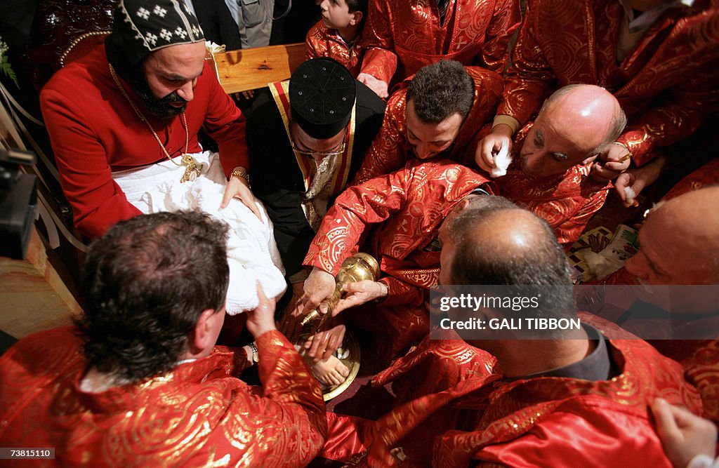 Syrian Orthodox priests wash the feet of...