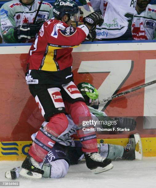 Sean Brown tackles Petr Fical of Nuremberg during the DEL Bundesliga play off semi final game between DEG Metro Stars and Nuremberg Ice Tigers at the...