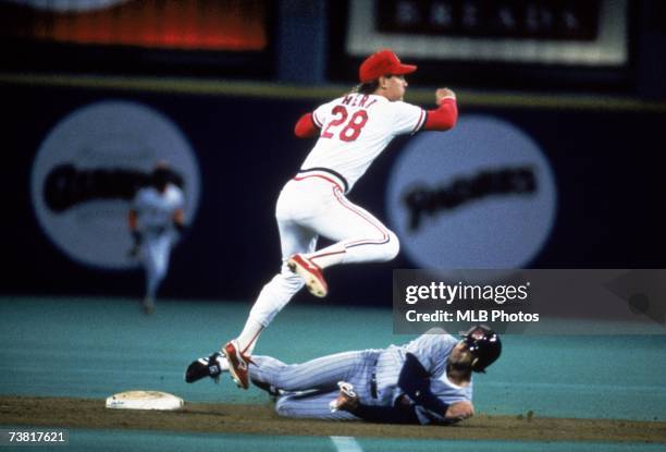 Tom Herr of the St. Louis Cardinals throws to first after forcing the out at second base during the 1987 World Series game against the Minnesota...