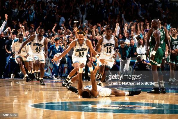 Alonzo Mourning and the Charlotte Hornets celebrate after winning game four of round one of the 1993 NBA Playoffs against the Boston Celtics in...