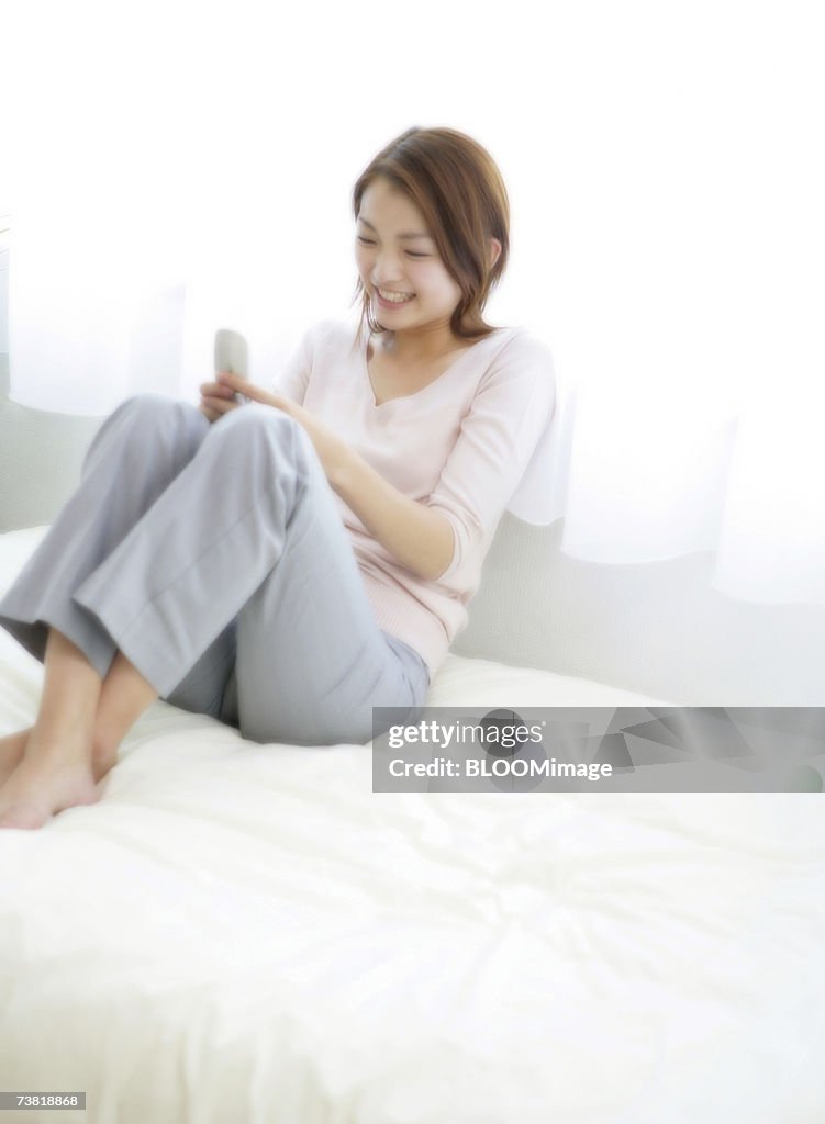 Japanese woman touching cell phone with smiling