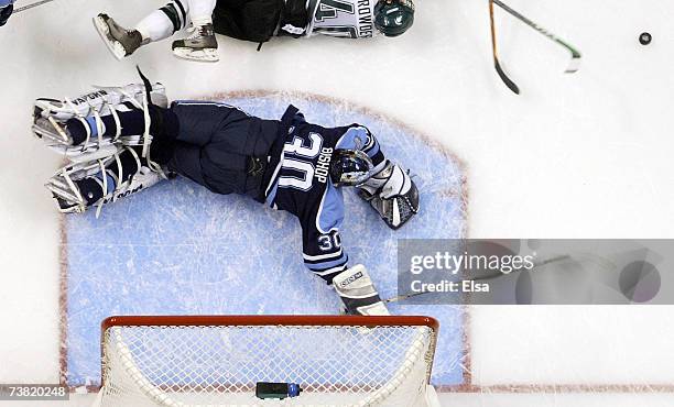 Ben Bishop of the Maine Blackbears stops a shot by Tim Crowder of the Michigan State Spartans during the Division I Frozen Four semifinals on April...