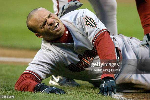 Scott Hairston of the Arizona Diamondbacks lies on the field after hitting a foul ball off his leg against the Washington Nationals at RFK Stadium...