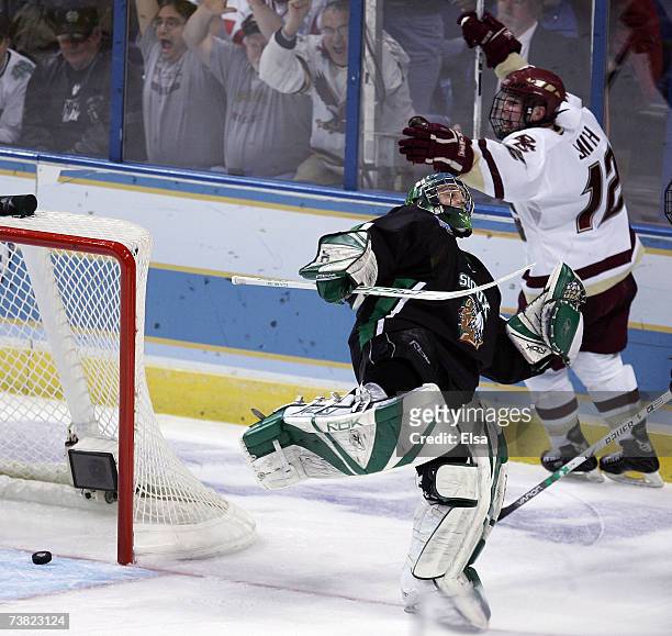 Ben Smith of the Boston College Eagles celebrates his goal as Jean-Philippe Lamoureux of the North Dakota Fighting stumbles during the Division I...