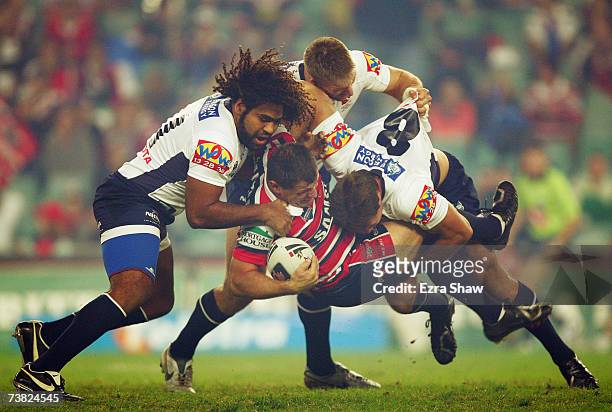 Danny Nutley of the Sydney Roosters is group tackled by the the Brisbane Broncos defence during the round four NRL match between the Sydney Roosters...