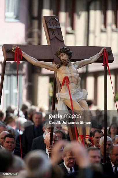 Members of the town's crafts guilds carry a likeness of Jesus Christ on the cross during a Good Friday procession on April 6 in Lohr am Main,...