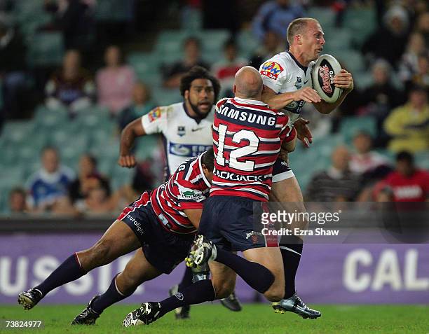Darren Lockyer of the Brisbane Broncos is tackled by the Sydney Roosters during the round four NRL match between the Sydney Roosters and the Brisbane...