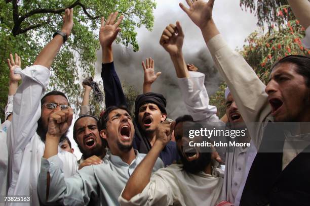 Students at an Islamic madrassa chant anti-American slogans while burning thousands of DVDs, videos and music CDs April 6, 2007 at the Lal Mosque in...