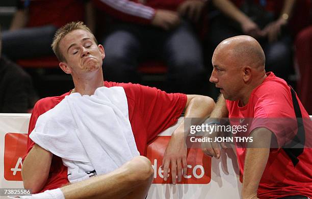 Belgian Kristof Vliegen grimaces next to his coach Julien Hoferlin during a time-braek of the Davis Cup quarter-final match against German Tommy...