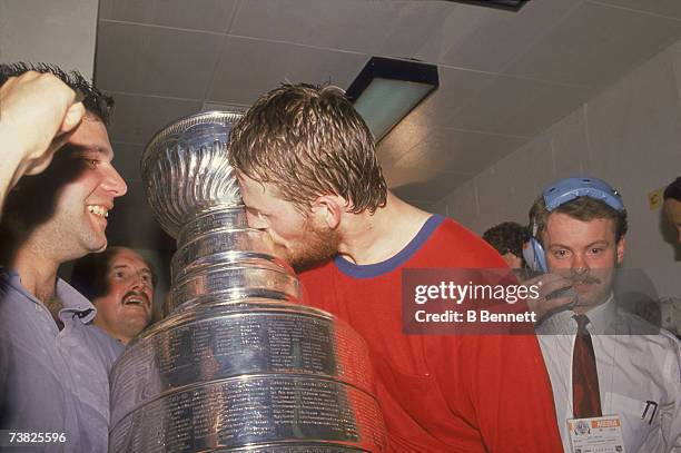 Canadian professional ice hockey player Gary Roberts of the Calgary Flames kisses the Stanley Cup award trophy as he celebrates after his team's...