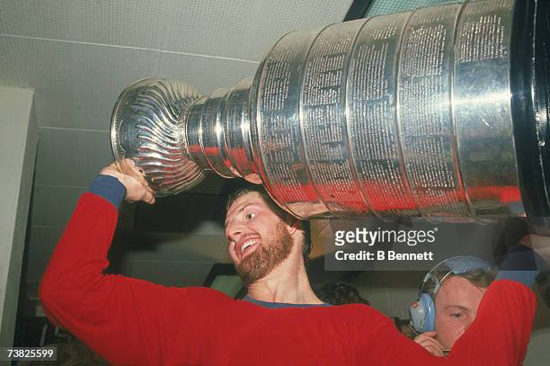 Canadian professional ice hockey player Gary Roberts of the Calgary Flames holds the Stanley Cup award trophy over his head as he celebrates after...