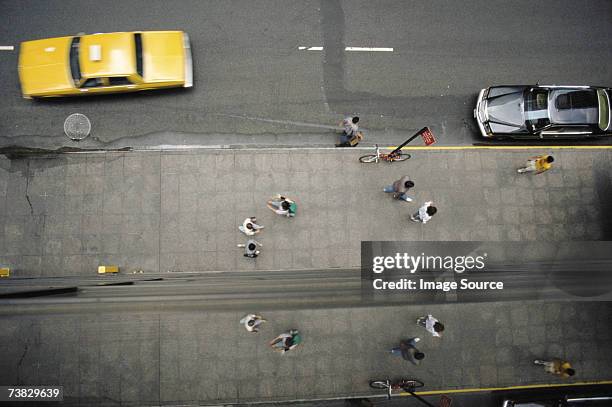 pedestrians and yellow taxi in new york - passant stock-fotos und bilder